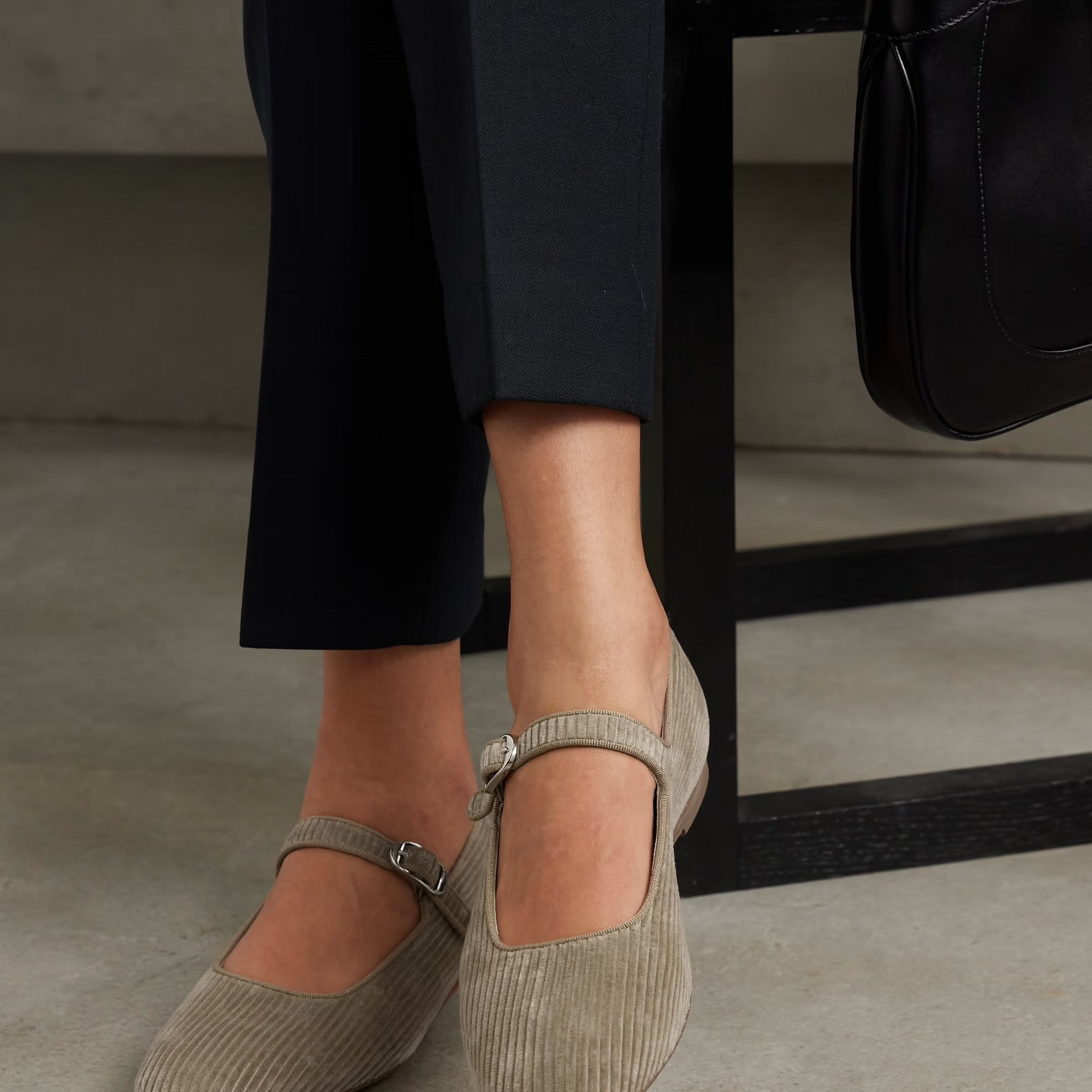 Model wears black pants with Le Monde Beryl ballet Mary Janes in brown cotton corduroy