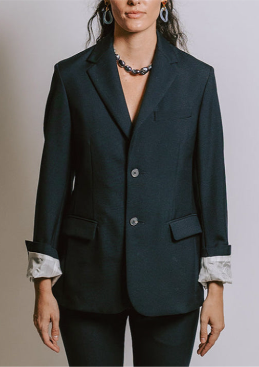 Close-up of model on grey backdrop in SOFIE D'HOORE CHU-WES black wool blazerJacket