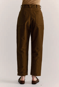 Back view of model wearing Casey Casey brown cotton Ikla Pants with brown clogs