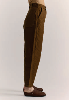 Side view of model wearing Casey Casey brown cotton Ikla Pants