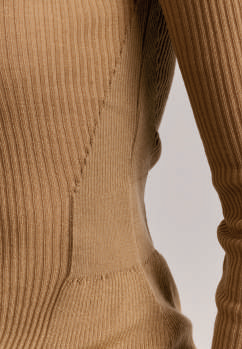 Close-up of ribbed knit fabric panel on side of Casey Casey sweater