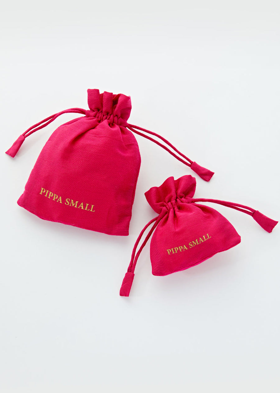 Two red drawstring pouches with 'Pippa Small' branding in gold
