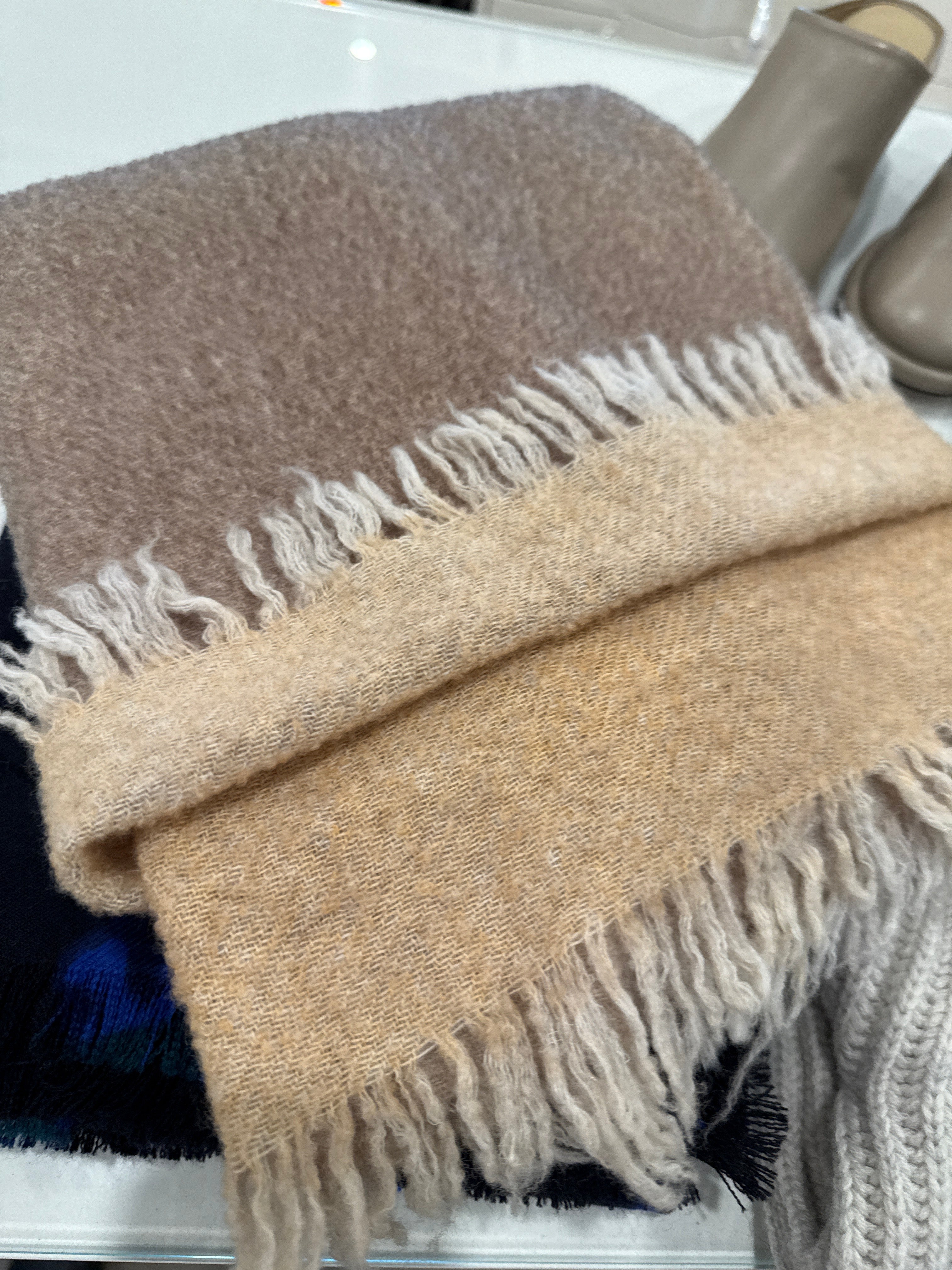 DESTIN reversible wool scarf in camel and light brown, with fringe, folded on counter