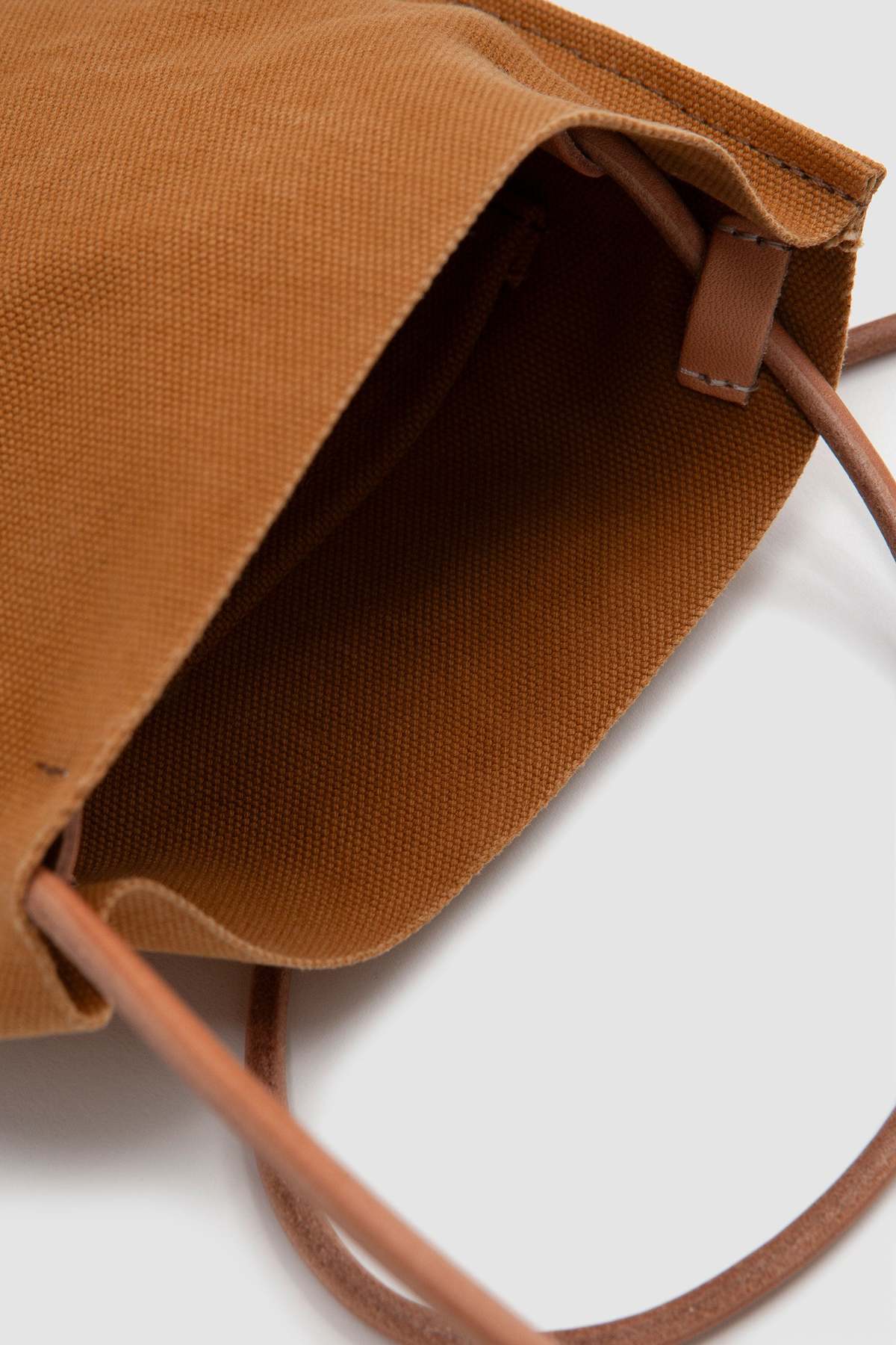 AMIACALVA tan Washed Canvas Pochette purse on its side, open top detail