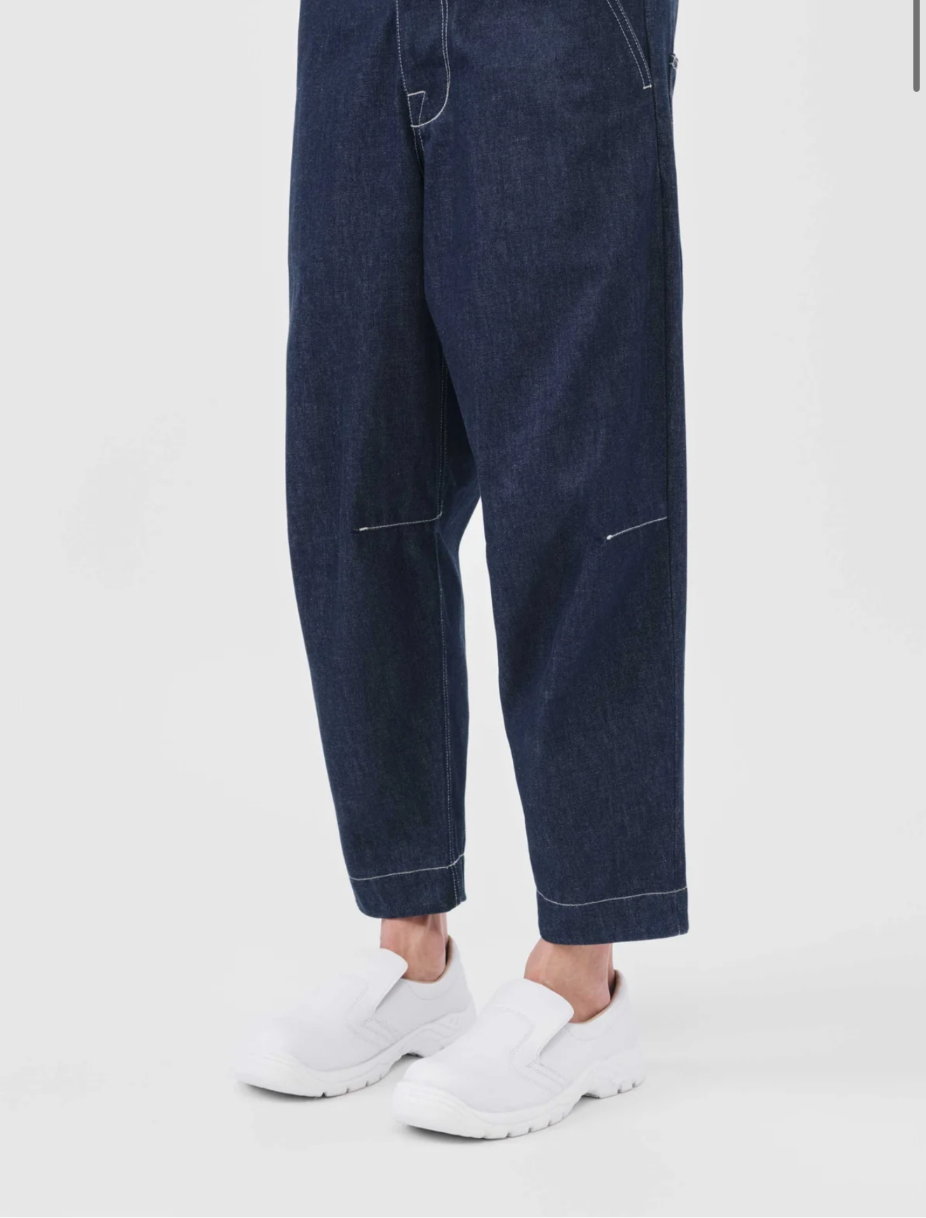 Close-up on model's legs in The Engineer Jean, with white sneakers