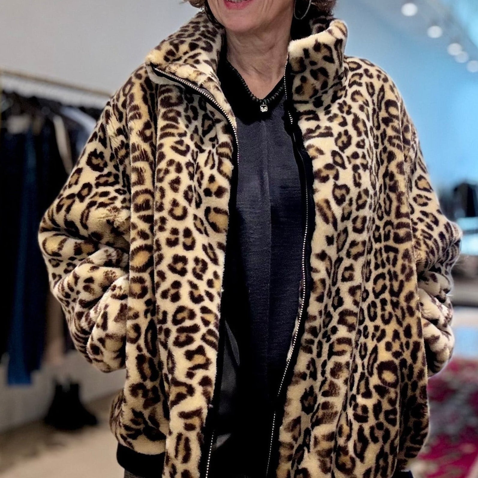 Model wears APOINT ETC faux fur, leopard-print Blouson Bomber jacket over black top, alt view
