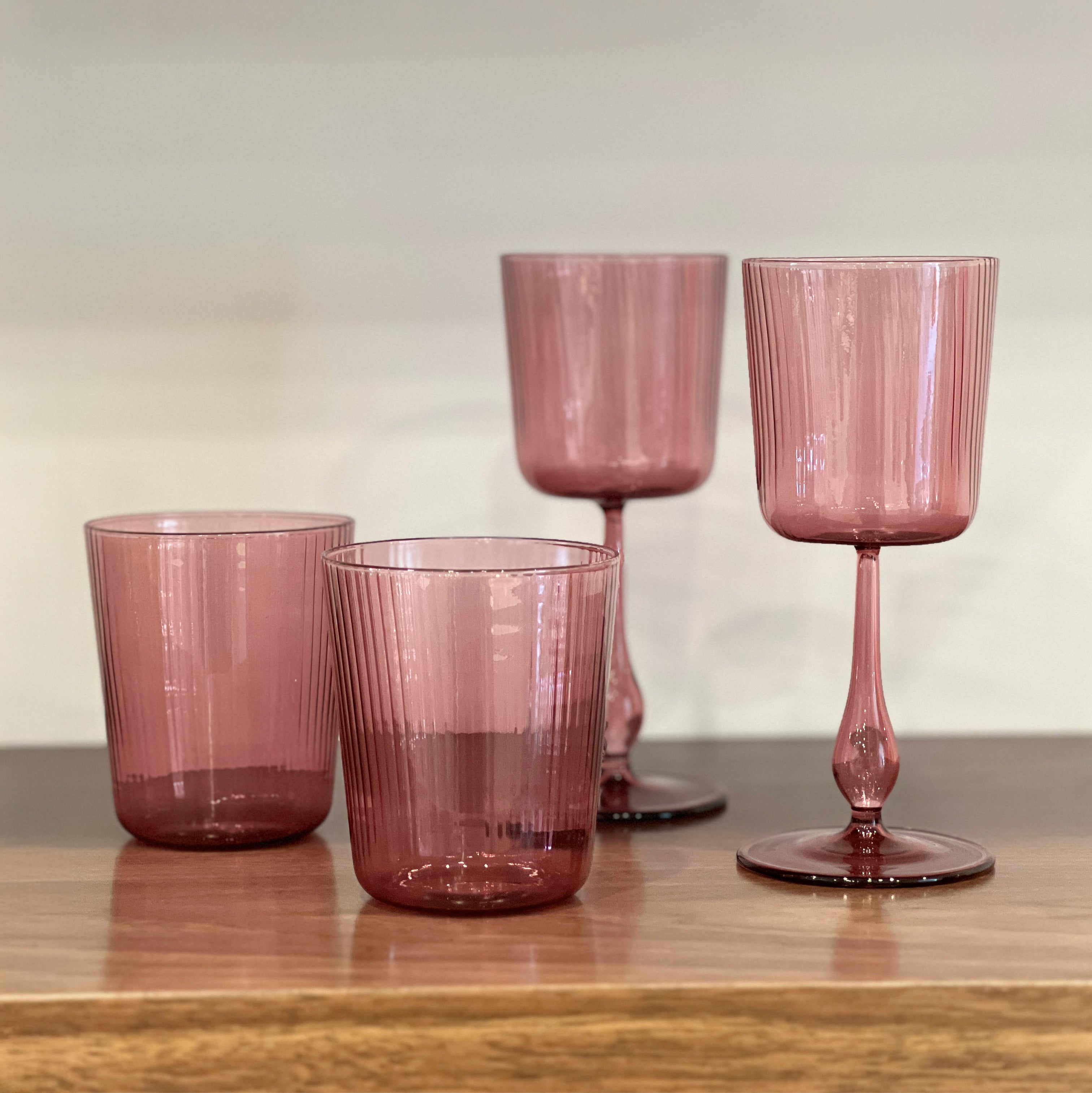 R+D.LAB Luisa Calice Wine Glasses, two dusty mauve ribbed wine glasses and tumblers on wooden shelf