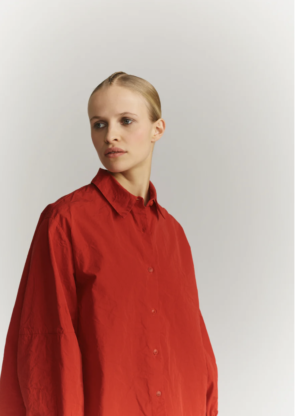 Women in an oversized bright red button-up.