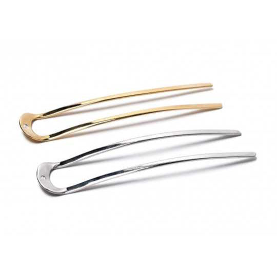 Sylvain Lehen epingle hair pins in gold and silver, on white backdrop